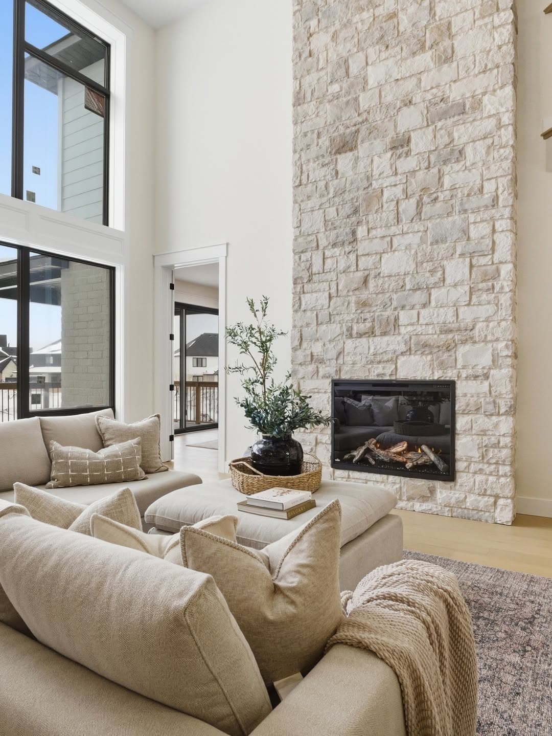 Living room with stone fireplace and vaulted ceilings